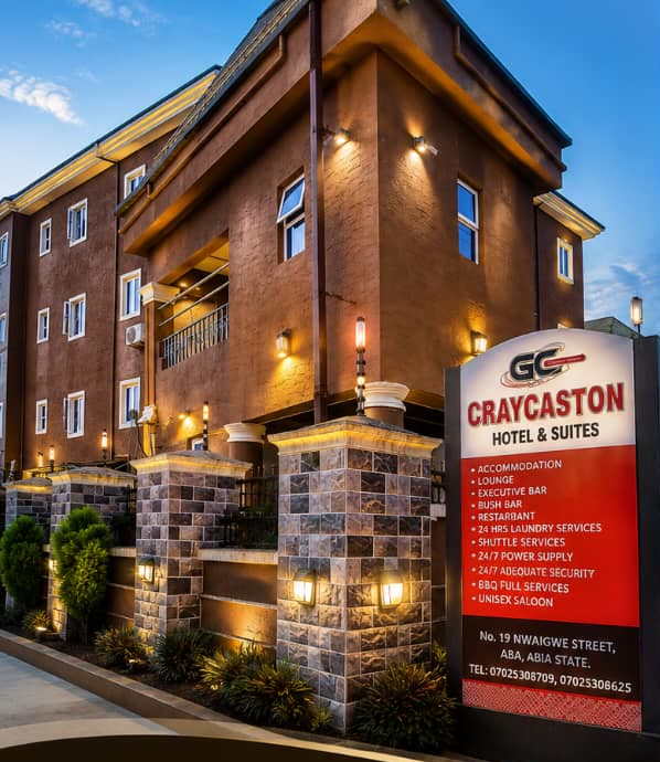 The lit facade of Craycaston Hotels & Suites on Nwaigwe Avenue, Aba, at dusk
